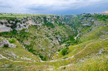 View of canyon with rocks and caves Murgia Timone, Matera Sassi, Italy