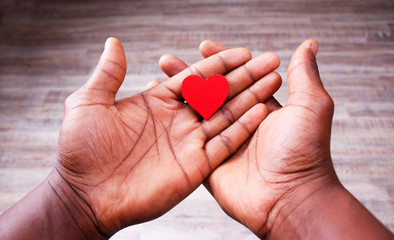 Red Heart in loving and Caring Human Palms