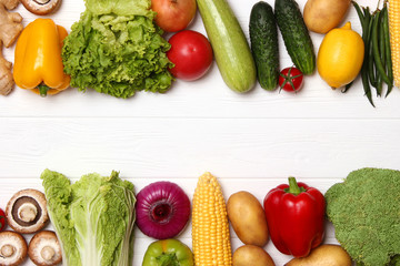 Different fresh vegetables on a wooden table top view. Proper and healthy food, diet, vegetarian. Cooking food, vegetable dishes. flat lay