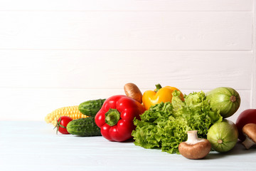 Set of different fresh vegetables on a wooden background. Diet, healthy food, veggie.