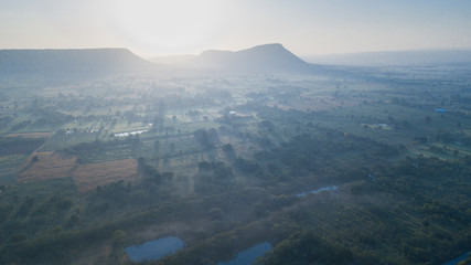 Surfaces on Livestock house, land and Cattle Farm in rural in Thailand with sunrise, fog and mountain background (photo by drone from hight view)