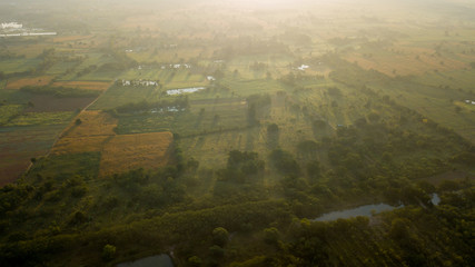 Surfaces on Livestock house, land and Cattle Farm in rural in Thailand with sunrise, fog and mountain background (photo by drone from hight view)