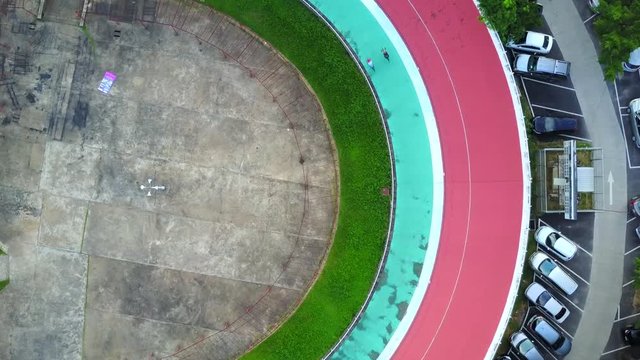 4K. Aerial view of velodrome with cyclists cycling on the track, a part of the Hua Mak Sports Complex in Bangkok, Thailand.