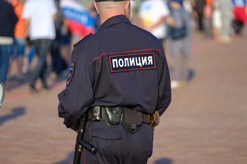 Policeman on the city street, back view
