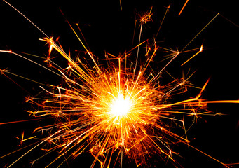 burning wire sparkler on black background
