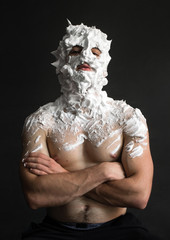 portrait of a strong guy smeared with shaving foam all over his face