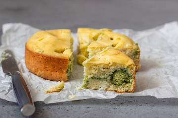 Corn cake with broccoli on parchment paper. 
