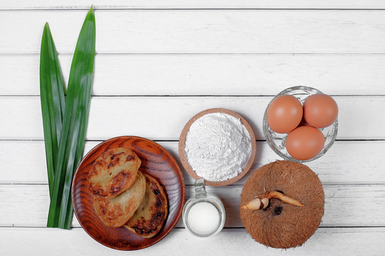 Akok Kedut, egg, coconut, flour , coconut milk and  Pandan leaf on wooden background. Akok Kedut is a traditional dish in Malaysia especially East Coast.