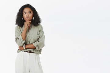 Woman thinking how get rid of troubles. Intense smart and thoughtful good-looking female...