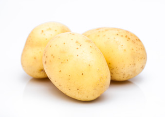 Three healthy organic baby potatoes on white background.