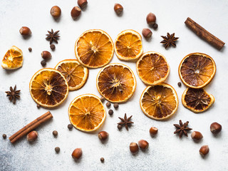 Bright Christmas or New Year background - dry orange slices and spices. Ingredients for making winter seasonal drink - mulled wine. Top view