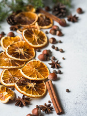 Bright Christmas or New Year background - dry orange slices and spices, spruce and cones. Ingredients for making winter seasonal drink - mulled wine.