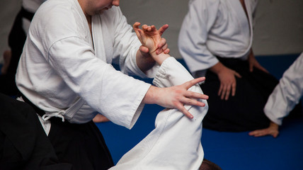 Aikido athletes train in the dojo. Aikidoki work out the elements of aikido equipment

