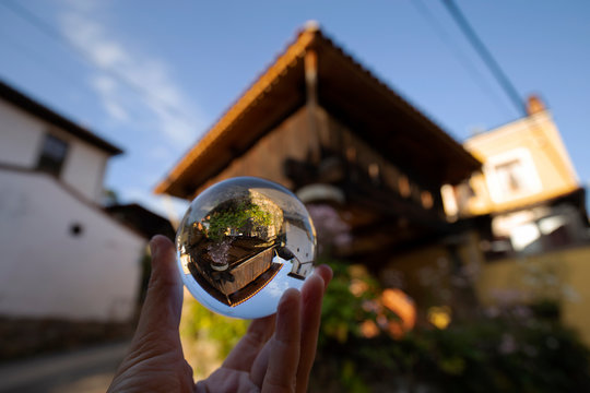 Horreo (raised granary) is reflected over a glass ball