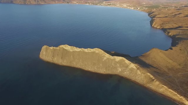 Rocky mountain coast bay aerial view. Shot. Beautiful landscape. Blue clear ocean sea water next to cliff Corfu Greece. Aerial view on beautiful sunset at Greece