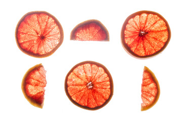 Cross section of a grapefruit on a lumen isolated on a white background. Half and whole grapefruit slices.