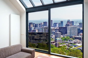 Fototapeta na wymiar Modern living room with large windows and view on city panorama