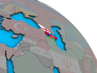 Fototapeta na wymiar Caucasus region with embedded national flags on simple blue political 3D globe.