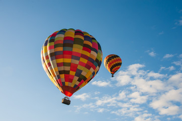 Fototapeta na wymiar Two multicoloured hot air balloons