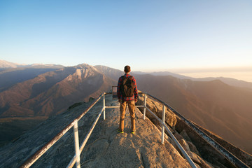 Travel in Sequoia National Park, man Hiker with backpack enjoying view Moro Rock, California, USA - obrazy, fototapety, plakaty