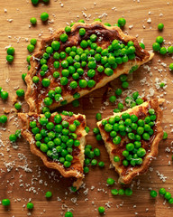 Homemade Cheese and sweet pea quiche, tart on wooden board