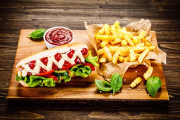 Hot dog and french fries on cutting board