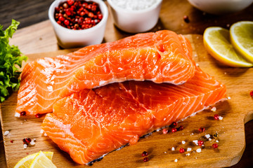 Fresh raw salmon fish served on cutting board on wooden table