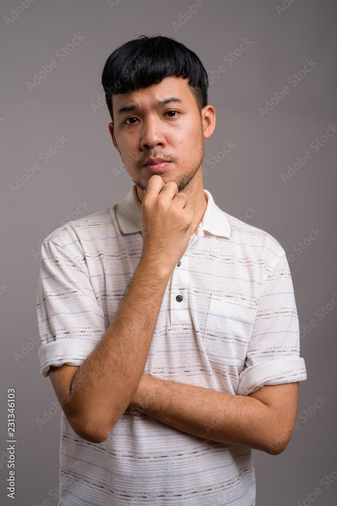 Sticker Portrait of young Asian man thinking and planning