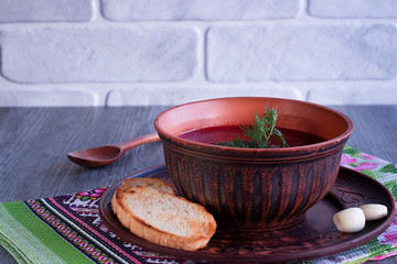 Borsch in brown bowl. Red soup. Dsh of Slavic, Russian, Ukrainian cuisine.