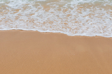 Fototapeta na wymiar soft wave on a sandy beach