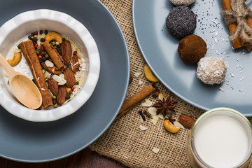 A plate with nuts, cinnamon. Blue dishes on burlap.