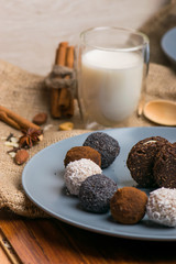 Candy and biscuit on a blue plate. Sweets on the fabric. A glass of milk