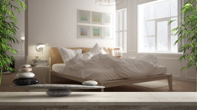 Wooden Vintage Table Or Shelf With Stone Balance, Over Blurred Scandinavian Bedroom With Messy Bed, Feng Shui, Zen Concept Architecture Interior Design