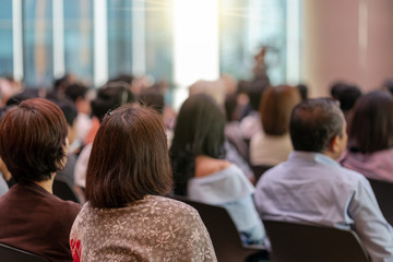 Rear view of Audience in the conference hall or seminar meeting which have Speakers are...