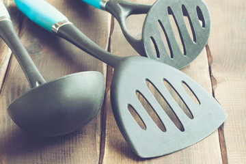 ladle and various kitchen utensils on wooden table