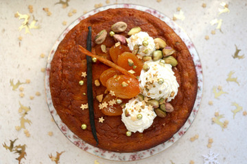 Dried apricot cake with mascarpone frosting, decorated for Christmas. Selective focus.
