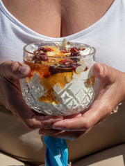Fruit sundae held by woman