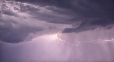 Naklejka na ściany i meble Thunderstrike from the colorful cloud at the heavy rain at night