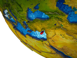 Cyprus on model of Earth with country borders and blue oceans with waves.
