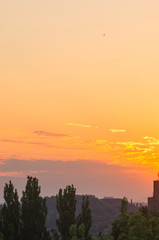 Landscape with dramatic light - beautiful golden sunset with saturated sky and clouds.