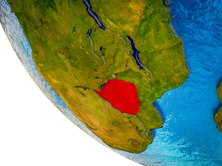 Zimbabwe on model of Earth with country borders and blue oceans with waves.