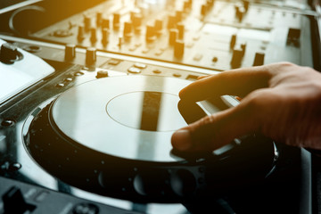 image of Dj playing music at mixer closeup