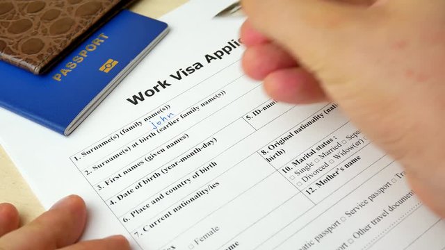 Work Visa application form with passport and pen. Document with passport, apply and permission for foreigner country