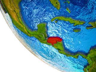 Honduras on model of Earth with country borders and blue oceans with waves.