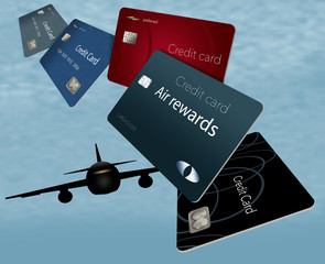 Air rewards credit cards are seen here floating and flying in the sky with airplanes in the background.