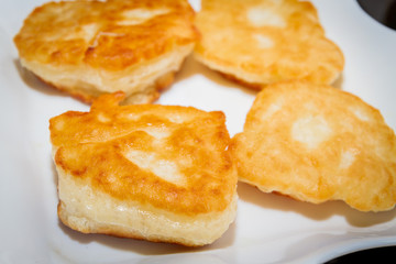 Freshly roasted pancakes are on a white plate