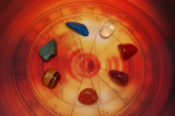 Healing gem stones lying on horoscope with zodiac signs like astrology and gem stone concept 
