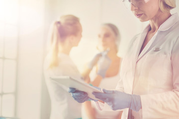 Fototapeta premium Beautiful woman face near doctor with syringe.