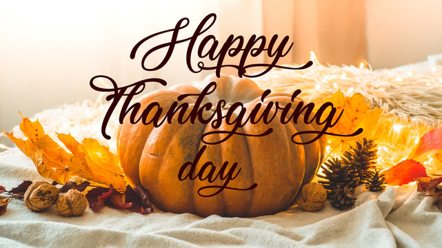 Happy thanksgiving text. In home decorated Pumpkin, cones, walnuts and autumn leaves garland. autumn fall holidays. Cozy mood