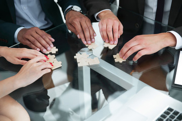 close up .multinational business team assembling puzzle.